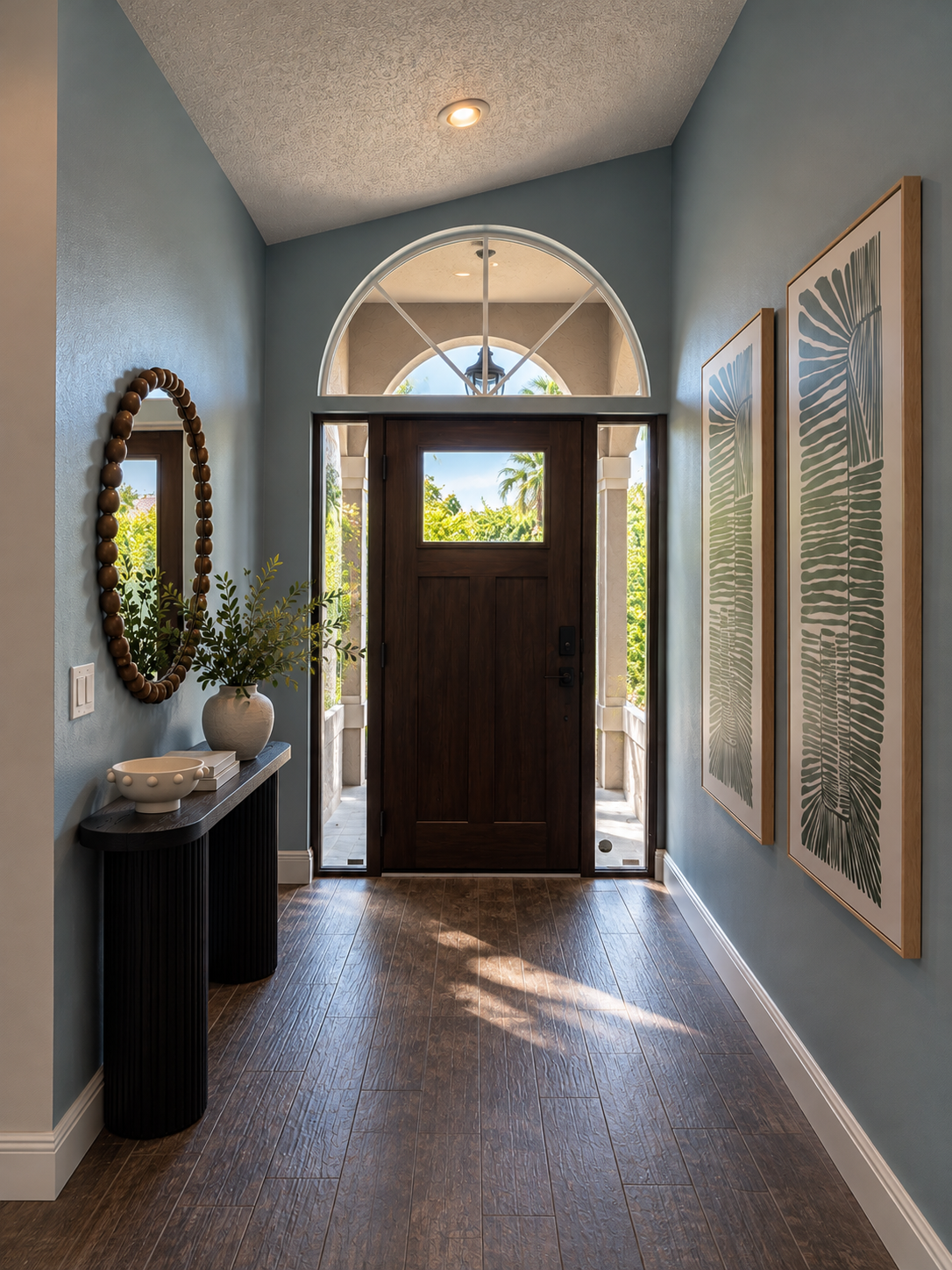 Modern coastal entryway with arched doorway at Dream Come True in Bradenton, Florida
